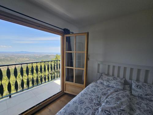 a bedroom with a bed and a large window at Finca Es Verger in Esporles
