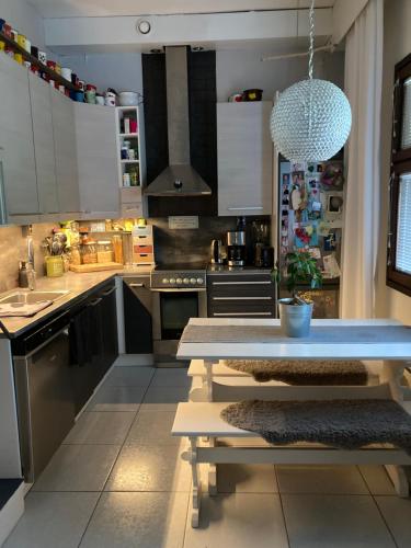 a kitchen with a blue table in a kitchen at Apartment for 5 people in Savonlinna