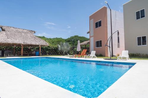 a swimming pool in front of a building at Residencial San Agustin Huatulco in Santa Cruz Huatulco