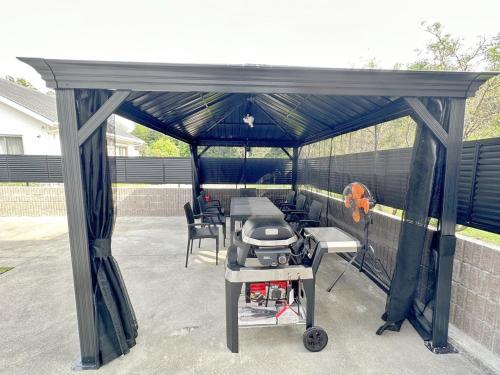 a gazebo with a grill on a patio at バブルハウス付き!白良浜徒歩10分!プール付き!BBQ雨でも可能!貸切!浅築5LDk in Shirahama