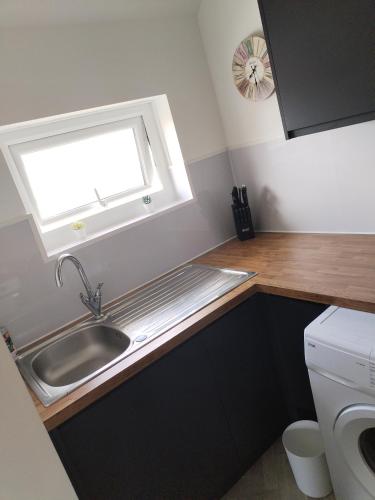 a small kitchen with a sink and a window at Flat sleeps 5 people in Guisborough in Guisborough