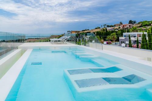 a swimming pool with blue water on top of a building at Villa La Perla in Licata