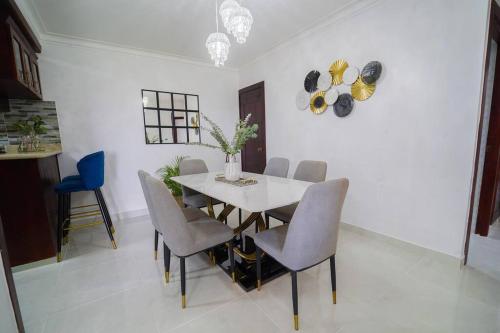 a dining room with a white table and chairs at Luxury & Private Apartment in Mendoza