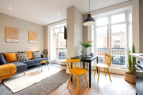 a living room with a couch and a table at Preston Apartments in Preston