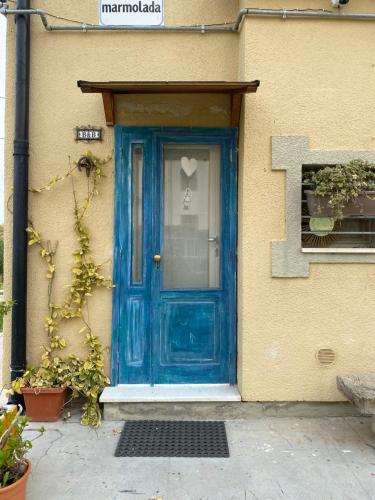 a blue door on the side of a building at B&B “il Pellicano” in Policoro