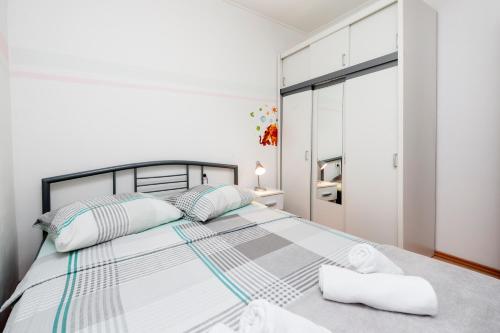 a bedroom with a large bed with two pillows at Rovinj Romance Apartment in Rovinj