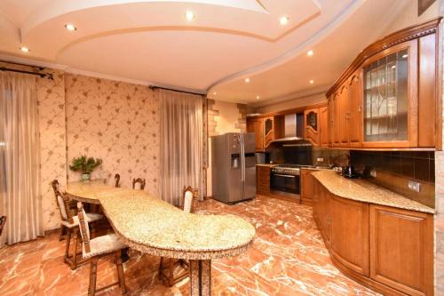 a kitchen with a counter top and a refrigerator at Freedom Apartments on Mher Mkrtchyan in Yerevan