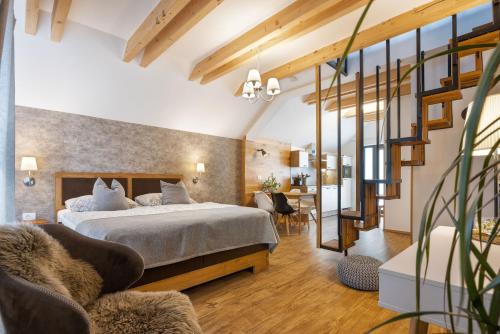 a bedroom with a bed and a living room at Hiša Vally Art in Bled