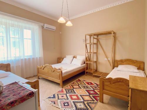 a room with two beds and a mirror in it at Hotel Magdalena in Mtskheta