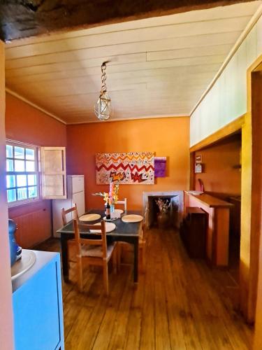 a dining room with a table and chairs and a fireplace at SOLAR DAS ARCAS Manor House in Arcas