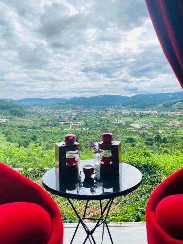 a table with three cups on it with a view at Nacasoo hill in Tiên Hai