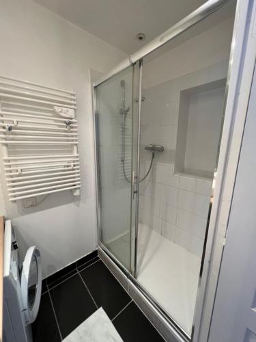 ein Bad mit einer Dusche und einer Glastür in der Unterkunft Nimes centre ville appartement cosy 2 chambres in Nîmes