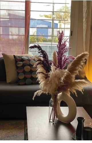 a vase with feathers on a table in a living room at Chilly in Sidi Bouzid