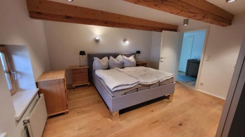 a bedroom with a bed and a wooden floor at Wohnung Panoramablick in Seefeld in Tirol