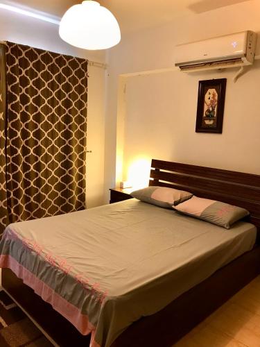 a bedroom with a large bed with a wall at Chalet Marina Wadi Degla Families Only Pool view 2nd floor with Roof 6 adults in Ain Sokhna