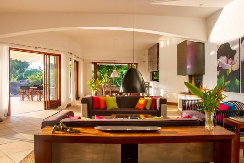 a living room with a couch and a table at Bougainvillea Retreat in Kandy