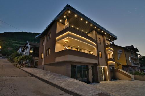 a building with lights on the side of it at SM Exclusive Apartments in Visoko