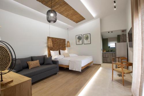 a living room with a bed and a couch at ELFAM CITY SUITES in Lefkada