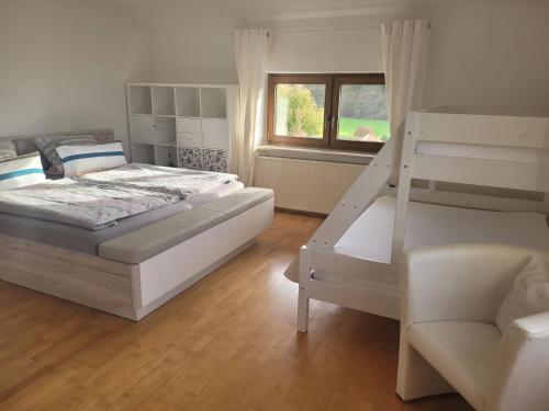 a bedroom with a bunk bed and a ladder at Ferienwohnung Hagner in Teisendorf