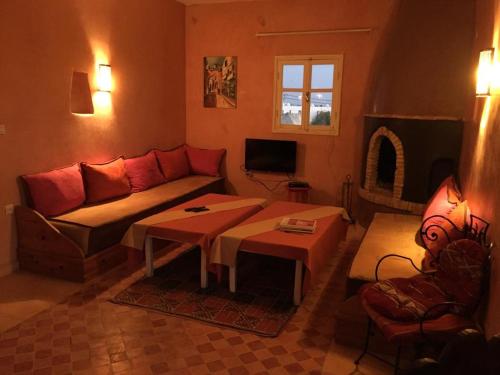 a living room with a couch and a table at Nour Mogador in Ghazoua