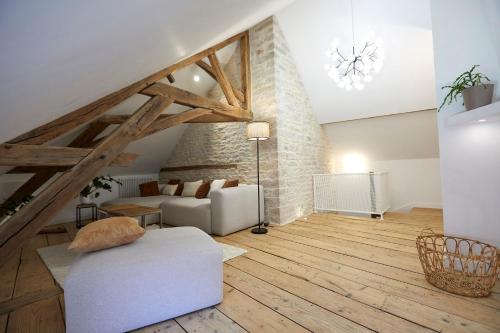 a living room with a white couch and a chair at Couette&Living - Maison design à Savigny-les-Beaune in Savigny-lès-Beaune