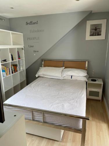 a bedroom with a large bed with at 2nd floor Enfield town studio flat in Enfield