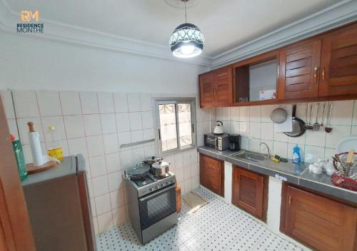 a small kitchen with a stove top oven in it at Résidence M Douala in Douala