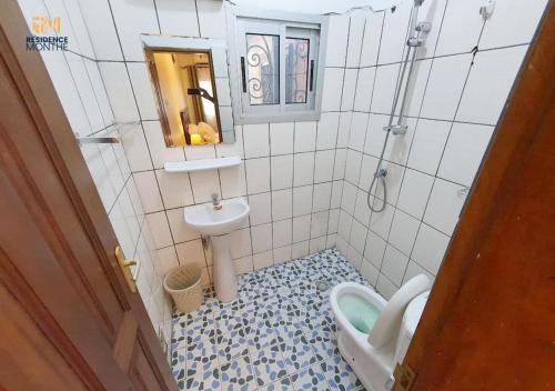 a small bathroom with a sink and a toilet at Résidence M Douala in Douala