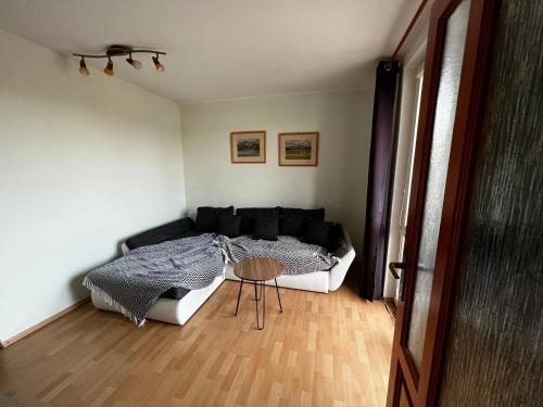 a living room with a bed and a table at Apartmán MW in Poprad