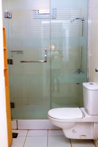 a bathroom with a toilet and a glass shower at Spring Hotel Luxor in Luxor