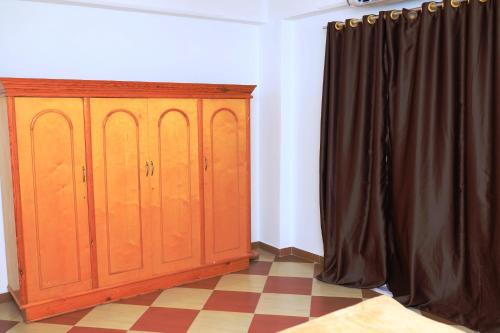 a room with wooden cabinets and a black curtain at Spring Hotel Luxor in Luxor