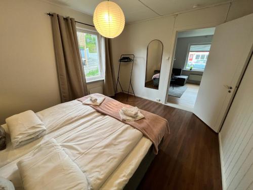 a bedroom with a large bed and a mirror at Central trainstation apartment in Narvik