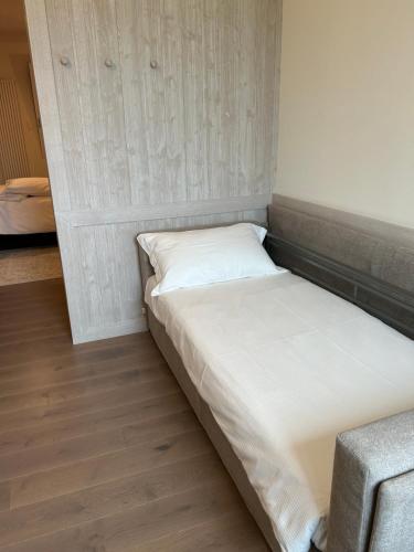 a bed in a room with a white bed frame at Ca' Barbieri San Donà in San Donà di Piave