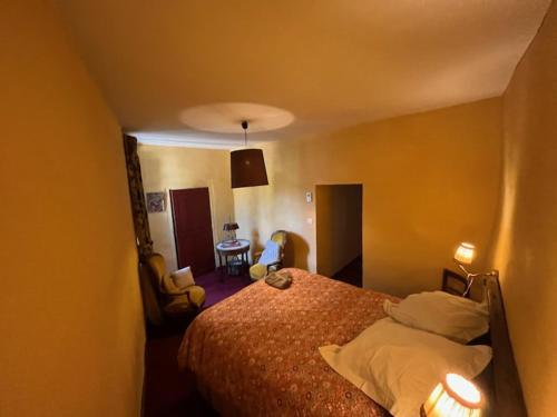 a bedroom with a bed with two lights on at Suite Provençale in Saignon