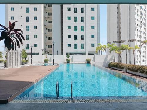 a large swimming pool with buildings in the background at Deluxe Suites 2, Netflix ,2-5 pax, Georgetown in George Town