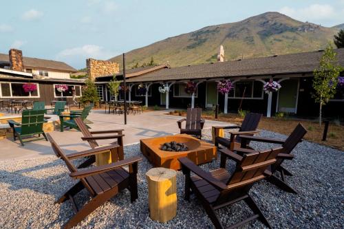 a patio with chairs and a fire pit in front of a building at The Virginian Lodge in Jackson
