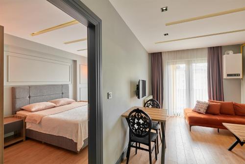 a bedroom with a bed and a mirror at Sofyapart in Soğuksu