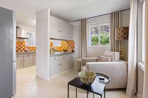 une cuisine et un salon avec un canapé et une table dans l'établissement Villa Bohème, à Saint-Tropez