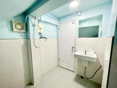 a bathroom with a shower and a sink at Naiharn On The Rock Resort Phuket in Nai Harn Beach