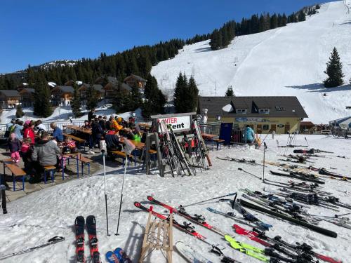 a group of skiers at a ski resort in the snow at Chalet Montana Royal XL Koralpe in Hartelsberg