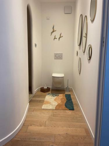 a bathroom with a toilet and a rug on the floor at CHAMBRE D HOTE in Porticcio