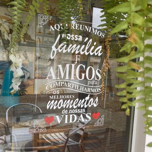 a sign in the window of a restaurant with the words at Pousada Rota dos Mares in Penha