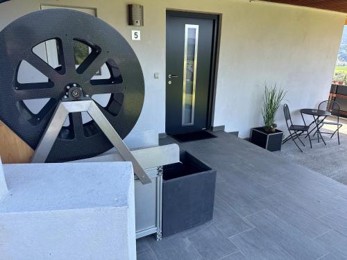 a large wheel sitting on the side of a house at Panoramablick Scheifling in Lind bei Scheifling