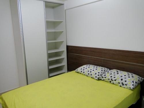 a bedroom with a green bed and a closet at Apartment Cabo Branco #4 in João Pessoa