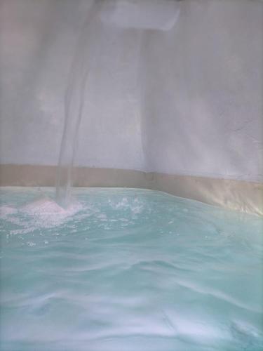 a hot tub with water shooting out of it at Dimore di Gio' Luxury Private Wellness Spa in Ostuni