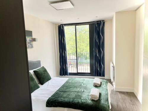 a bedroom with a bed and a large window at Luxuries 2 Bed Room Flat in Canary Wharf in London