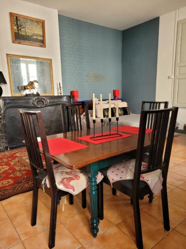 une salle à manger avec une table et des chaises en bois dans l'établissement Studio Séquoia au pied du Château, à Saumur