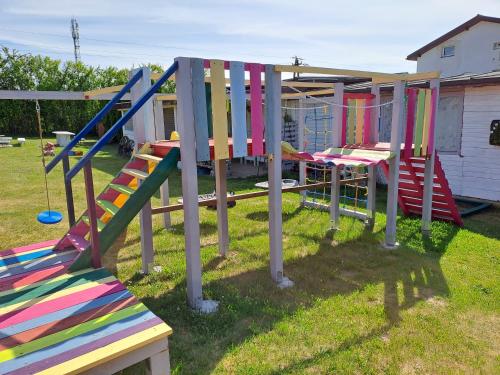 a group of colorful playground equipment in a yard at Domki letniskowe u Bożeny in Krokowa
