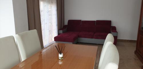a living room with a wooden table and a couch at Apartamento Salamanca in Guardamar del Segura