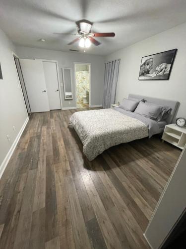 a bedroom with a bed and a ceiling fan at Beautiful single story 4 br. home in nice area. in Palmdale